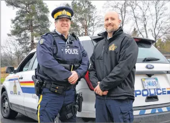  ?? LAWRENCE POWELL ?? Adam Burns, right, Annapolis District RCMP community programs officer, and Cpl. Tim Hawkes hope to fill the back of this RCMP SUV several times during Cram the Cruiser events planned for Middleton and Bridgetown between now and Christmas.