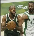  ?? AP photo ?? Khris Middleton of the Bucks shoots past the Celtics’ Kemba Walker during the first half of Milwaukee’s 121-119 victory over Boston on Wednesday.