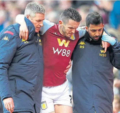  ?? Picture: PA. ?? John McGinn is helped off after breaking an ankle at Villa Park on Saturday.