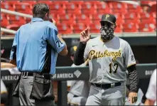  ?? Associated Press ?? Socially distant: Pittsburgh Pirates manager Derek Shelton (17) argues with home plate umpire Jordan Baker during the third inning OF A BASEBALL GAME AGAINST THE ST. LOUIS CARDINALS SUNDAY IN ST. LOUIS.