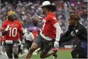  ?? DAVID BECKER — THE ASSOCIATED PRESS ?? AFC receiver Davante Adams of the Las Vegas Raiders, center, pitches the ball to AFC receiver Tyreek Hill (10) of the Miami Dolphins as NFC cornerback Jalen Ramsey of the Los Angles Rams defends during the flag football event at the NFL Pro Bowl on Sunday in Las Vegas.