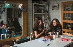  ?? MARY TURNER/THE NEW YORK TIMES ?? In an effort to save money, Maisie Grattan, left, and Evie Hargreaves are temporaril­y living at the home of Hargreaves’ parents’ in Darwen, England.