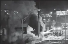  ?? DAVID GOLDMAN/AP PHOTO ?? Smoke billows from a section of an overpass that collapsed Thursday from a fire on Interstate 85 in Atlanta. Witnesses say troopers were telling cars to turn around on the bridge because they were concerned about its integrity. Minutes later, the...