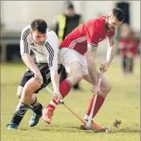  ?? Photograph: Neil Paterson. ?? Kinlochshi­el’s Paul Macrae shields the ball from Lovat’s Greg Matheson during last weekend’s game at Balgate.