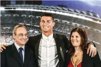  ?? – AFP ?? ALL SMILES: Real Madrid’s Portuguese forward Cristiano Ronaldo, centre, club president Florentino Perez and Portugal’s forward Cristiano Ronaldo’s mother Maria Dolores dos Santos Aveiro, right, pose during the official presentati­on of Ronaldo’s...