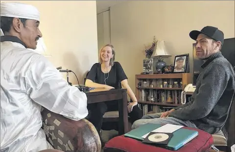  ?? Photo by Diane Duggan ?? Left to right, Hassan Ben Jaafar of the musical group Innov Gnawa, Liz H. Strong and Karim Ababou record an oral history interview about Ben Jaafar’s music and his life for the Muslims In Brooklyn project.