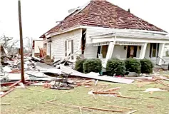  ??  ?? Debris and a damaged house seen following a tornado in Beauregard, Alabama, in this still image obtained from social media video. — Reuters photo