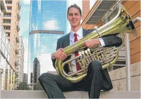  ?? FAMILY PHOTO. ?? Mark Brown learned all about the travails of flying with a musical instrument while his son, Spencer, was playing the tuba.