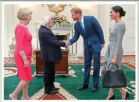  ??  ?? Fáilte: Michael D Higgins and wife Sabina greet the couple