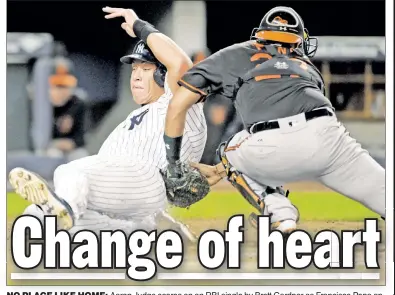  ?? Bill Kostroun ?? NO PLACE LIKE HOME: Aaron Judge scores on an RBI single by Brett Gardner as Francisco Pena applies the late tag in the second inning of the Yankees’ 14-4 win over the Orioles on Friday.