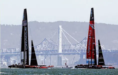  ?? Photos by Beck Diefenbach / Special to The Chronicle ?? Oracle Team USA chases Team New Zealand toward the third marker during the first of two America’s Cup finals races.