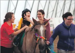  ??  ?? For the past 20 years, Rainbow Riders has operated a therapeuti­c riding program to help countless Newfoundla­nd and Labrador children grow and develop despite physical, cognitive and emotional disabiliti­es – all through horseback riding.