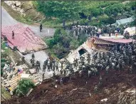  ?? AP/Kyoda News/TSUYOSHI UEDA ?? Rescuers search for survivors Friday at the site of a landslide in Atsuma, Japan, that was triggered by Thursday’s earthquake.