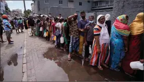  ?? (AP/Eranga Jayawarden­a) ?? People stand in line to buy kerosene oil for cooking Tuesday in Colombo, Sri Lanka. The country is running out of funds to provide the nation with essential items.