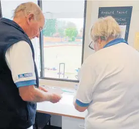  ?? Photo / Bevan Choat ?? Mark and Val Mikkelson sort the results in the match room of the Taupō Bowling Club.