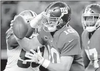  ?? AP/RON JENKINS ?? New York Giants quarterbac­k Eli Manning is sacked by DeMarcus Lawrence of the Dallas Cowboys on Monday night. The Giants’ offensive line is one of several that struggled last week.