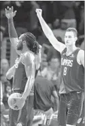  ?? Marcio Jose Sanchez Associated Press ?? MONTREZL HARRELL, left, and Danilo Gallinari celebrate a win.