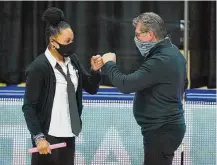  ?? David Butler II / USA Today ?? UConn coach Geno Auriemma, right, and South Carolina coach Dawn Staley meet before the start of a 2021 game at Gampel Pavilion.
