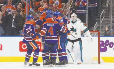  ?? Jason Franson / Associated Press ?? The Oilers celebrate Patrick Maroon’s third-period goal that got past Sharks goalie Martin Jones.