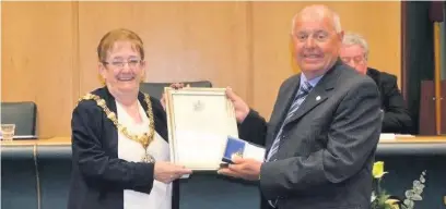  ??  ?? Brian Roberts received the title of Honorary Alderman from then Hyndburn Mayor Marlene Haworth