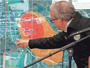  ?? AP PHOTO/GENE J. PUSKAR ?? Gov. Mike Dewine points to a map of East Palestine showing an area of largely rural Ohio evacuated after a train derailment and fire earlier this month released toxic chemicals.