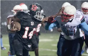  ?? MICHAEL SEARS / MILWAUKEE JOURNAL SENTINEL ?? Isiah Wright rushed for a career-high 341 yards and six touchdowns against Marshall in a rainy City Conference championsh­ip game Friday.