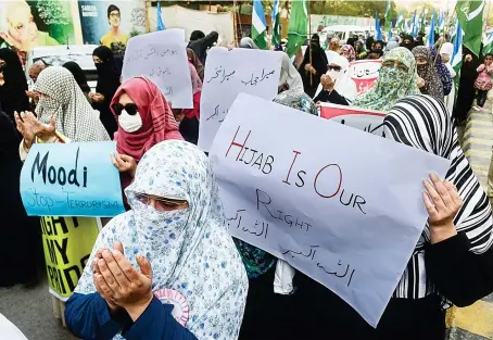  ?? File/AFP ?? Supporters stage a protest in Karachi in February last year against a hijab ban in educationa­l institutes of India’s Karnataka state.