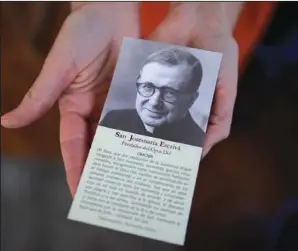  ?? (AP/Victor R. Caivano) ?? Josefina Madariaga, director of Opus Dei’s press office in Argentina, holds a photo of Opus Dei founder Josemaria Escriva de Balaguer on Nov. 4 in Buenos Aires.