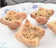  ?? ALYSHA WITWICKI ?? Spinach, Crab and Artichoke Mini Tarts make tasty use of puff pastry.