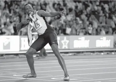  ?? Associated Press ?? n Jamaica's Usain Bolt performs his trademark pose on the finish line after placing third in the men's 100m final during the World Athletics Championsh­ips on Saturday in London.