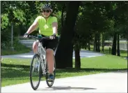  ?? NWA Democrat-Gazette/DAVID GOTTSCHALK ?? Kylie Gatewood rides Friday on the Razorback Greenway in Bentonvill­e. Gatewood was participat­ing in the Great Cycling Challenge and raising money for children’s cancer care and research.