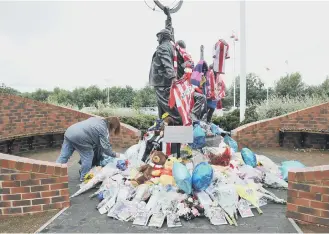  ??  ?? The statue by the entrance to the Stadium of Light has been decorated with items in tribute to Bradley Lowery.