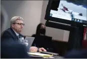  ?? SEAN RAYFORD — POOL PHOTO ?? Defendant William “Roddie” Bryan listens to an attorney as police body camera footage is shown during trial at the Glynn County Courthouse in Brunswick, Ga., on Monday.