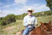  ??  ?? Howard Gershon, who boards his horse at Centaurus Ranch, rides along a section of trail outside Aldea de Santa Fe where he and other equestrian­s are allowed to ride.