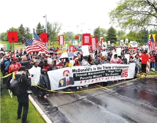  ?? REUTERS ?? COOKS, cashiers and other minimum wage earners join anti-Trump activists on a march for an increase in the minimum wage to $15/hour during a “March on McDonald’s” in Oak Brook, Illinois, US, May 24. Hundreds of McDonald’s employees from Pennsylvan­ia,...