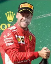  ?? AFP ?? In this file photo, Sebastian Vettel of Ferrari celebrates on the podium after finishing second best at the Formula One Hungarian Grand Prix in Mogyorod near Budapest. —