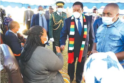  ?? — Picture: Tawanda Mudimu ?? President Mnangagwa consoles one of Lt Gen Edzai Chimonyo’s children Tinashe, while nephew Simba Simoyi (in blue jeans) looks on, in Greystone Park, Harare, yesterday.