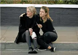  ?? Reuters ?? An injured woman and her colleague react outside Parsons Green tube station in London after the blast on Friday. —