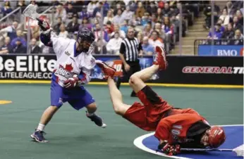  ?? CARLOS OSORIO/TORONTO STAR ?? Rob Hellyer hammers Calgary’s Curtis Manning during first-half NLL action Friday night at the Air Canada Centre. Stephan Leblanc scored five goals, Rob Hellyer three, Colin Doyle and Josh Sanderson two each for Rock