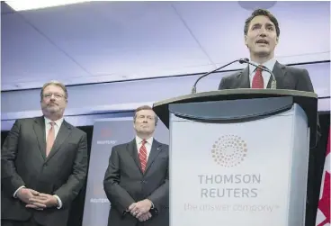  ?? CHRISTOPHE­R KATSAROV / THE CANADIAN PRESS ?? Thomson Reuters CEO Jim Smith, left, and Toronto Mayor John Tory look on as Prime Minister Justin Trudeau speaks at Friday’s announceme­nt.