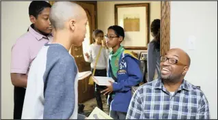  ??  ?? Author and poet Kwame Alexander, who won the Newbery Medal for his book ‘The Crossover’, talks with kids at book-signing event. PICTURE: WASHINGTON POST