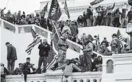  ?? Getty Images ?? Rioters force their way into the Capitol building on Wednesday after a Trump rally.