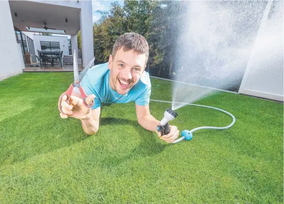  ??  ?? New dad Josh Miller is obsessed with his pride-and-joy, the beautiful lawn in his backyard. Picture: Rob Leeson