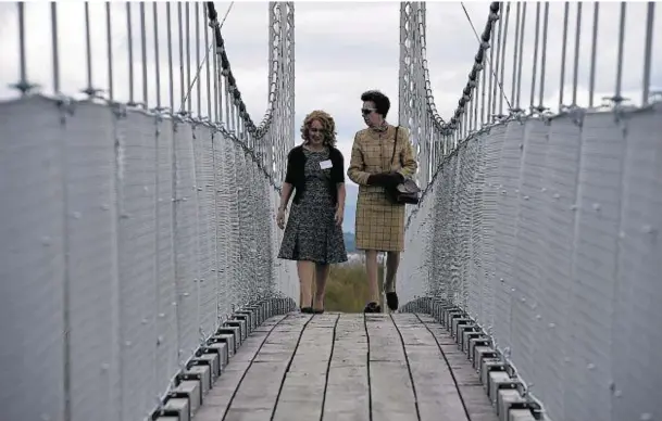  ?? Photograph­s: Sandy McCook ?? STEPPING OUT: The Princess Royal, right, walks across the Alexandra footbridge yesterday with Councillor Fiona Robertson of Highland Council.