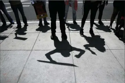  ?? JAE C. HONG — THE ASSOCIATED PRESS ?? Protesters cast their shadows as they chant slogans during a rally outside the the Millennium Biltmore Hotel Tuesday in Los Angeles. U.S. Attorney General Jeff Sessions is scheduled to give a speech at the hotel.