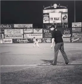  ?? SUBMITTED PHOTO ?? Mike Provine works as the first base umpire during an Eastern League game at Arm & Hammer Park. Provine, a West Windsor North graduate, is one of thousands of umpires out of work during the sports shutdown caused by the Covid-19pandemic.