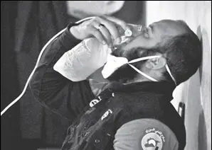  ?? REUTERS ?? A civil defence member breathes through an oxygen mask, after what rescue workers described as a gas attack on the town of Khan Shaykhun in rebelheld Idlib, Syria