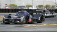  ?? JOHN RAOUX — THE ASSOCIATED PRESS ?? Dane Cameron (6) drives the Penske Team Acura DPI through a horseshoe turn testing for the IMSA 24hour auto race at Daytona Internatio­nal Speedway, Friday in Daytona Beach, Fla.