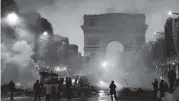  ?? CHRISTOPHE ENA AP ?? French police fired tear gas and water cannons to disperse violent demonstrat­ors near the Arc de Triomphe in Paris,