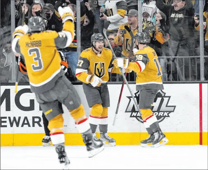  ?? John Locher
The Associated Press ?? Defenseman Shea Theodore, center, celebrates after his goal Saturday night against Tampa Bay. Theodore collected his first three-point game of the season.